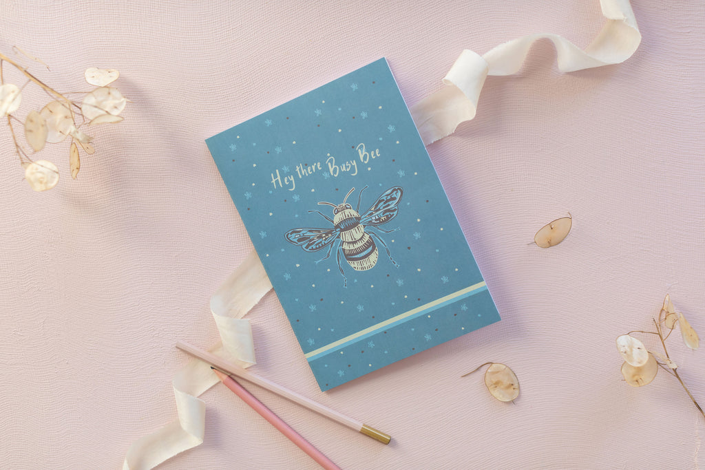 Notepad featuring "To Plant a garden, is to believe in tomorrow' slogan, with pink flowers
